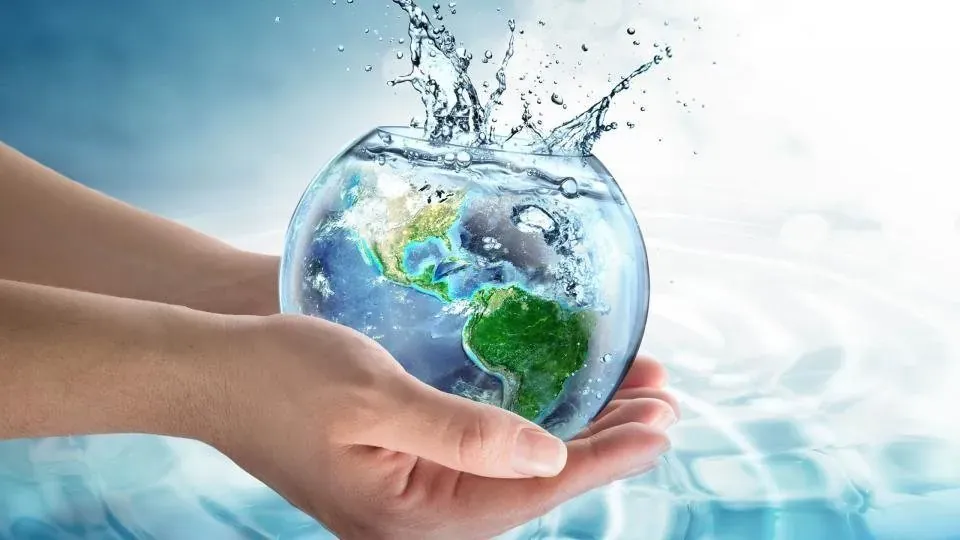 Hands holding a globe of water